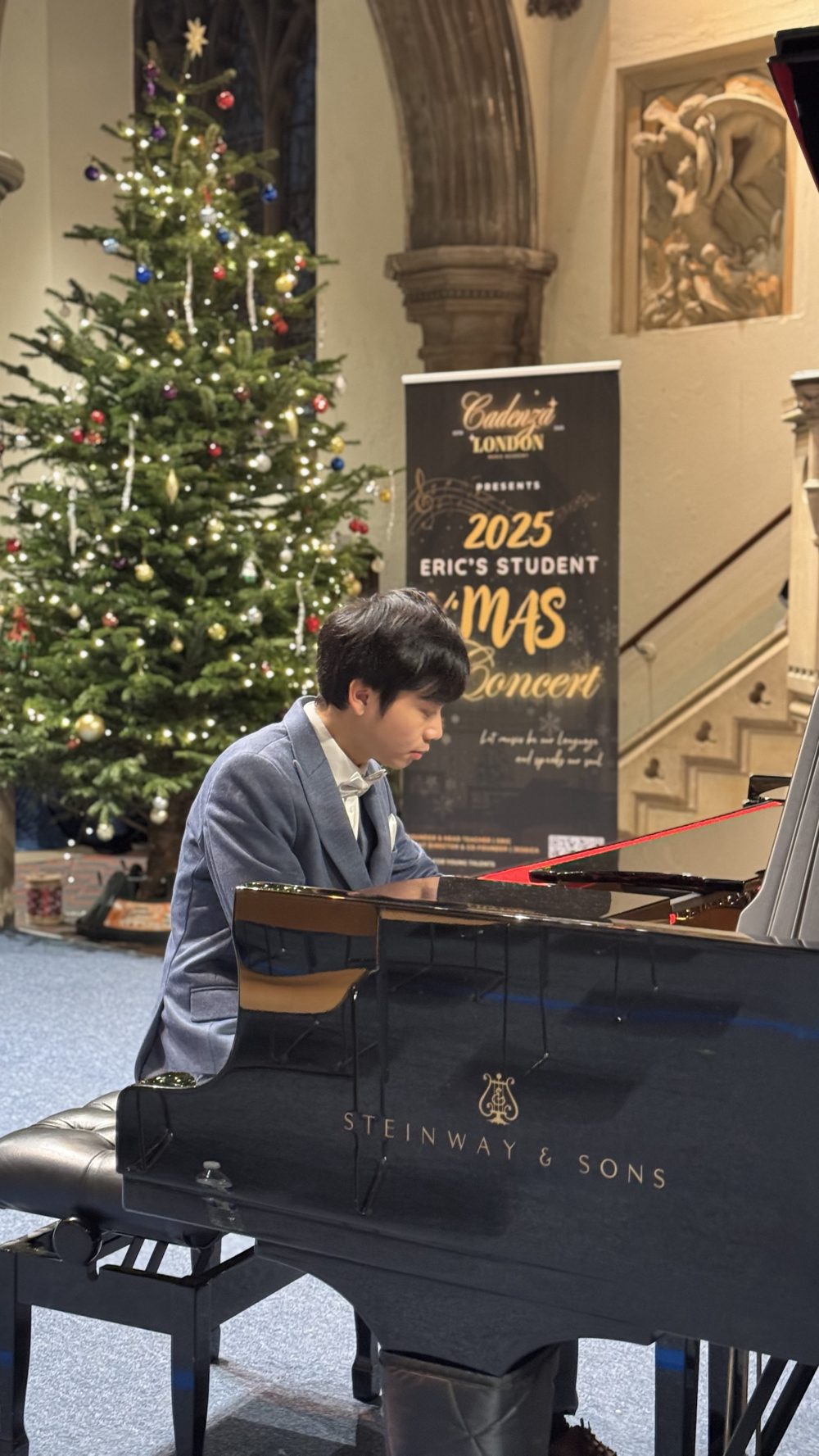 Eric Chung playing a Steinway grand piano at the Cadenza London 2025 student Christmas concert