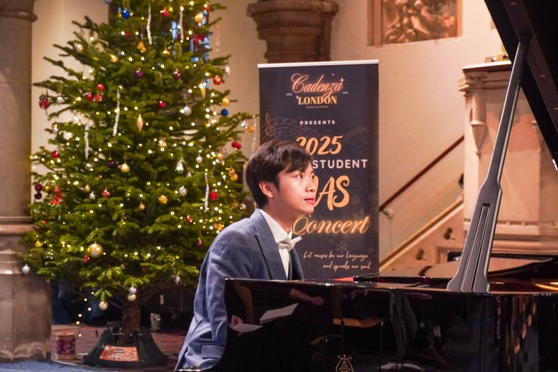 Eric Chung performing on a Steinway grand piano beside a Christmas tree