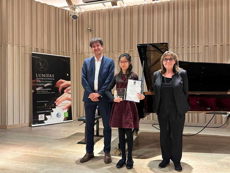 Hongyi, a piano student of Eric Chung at Cadenza London Music Academy, holding her Second Prize trophy and certificate at the Royal Academy of Music